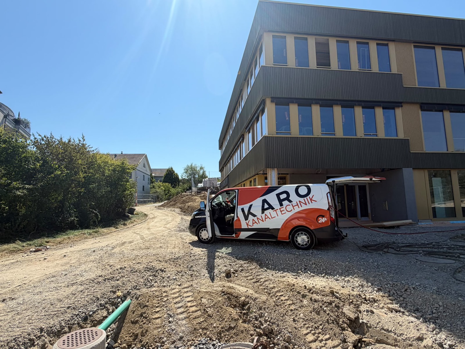 Einsatzfahrzeug von Karo Kanaltechnik vor einem Neubau